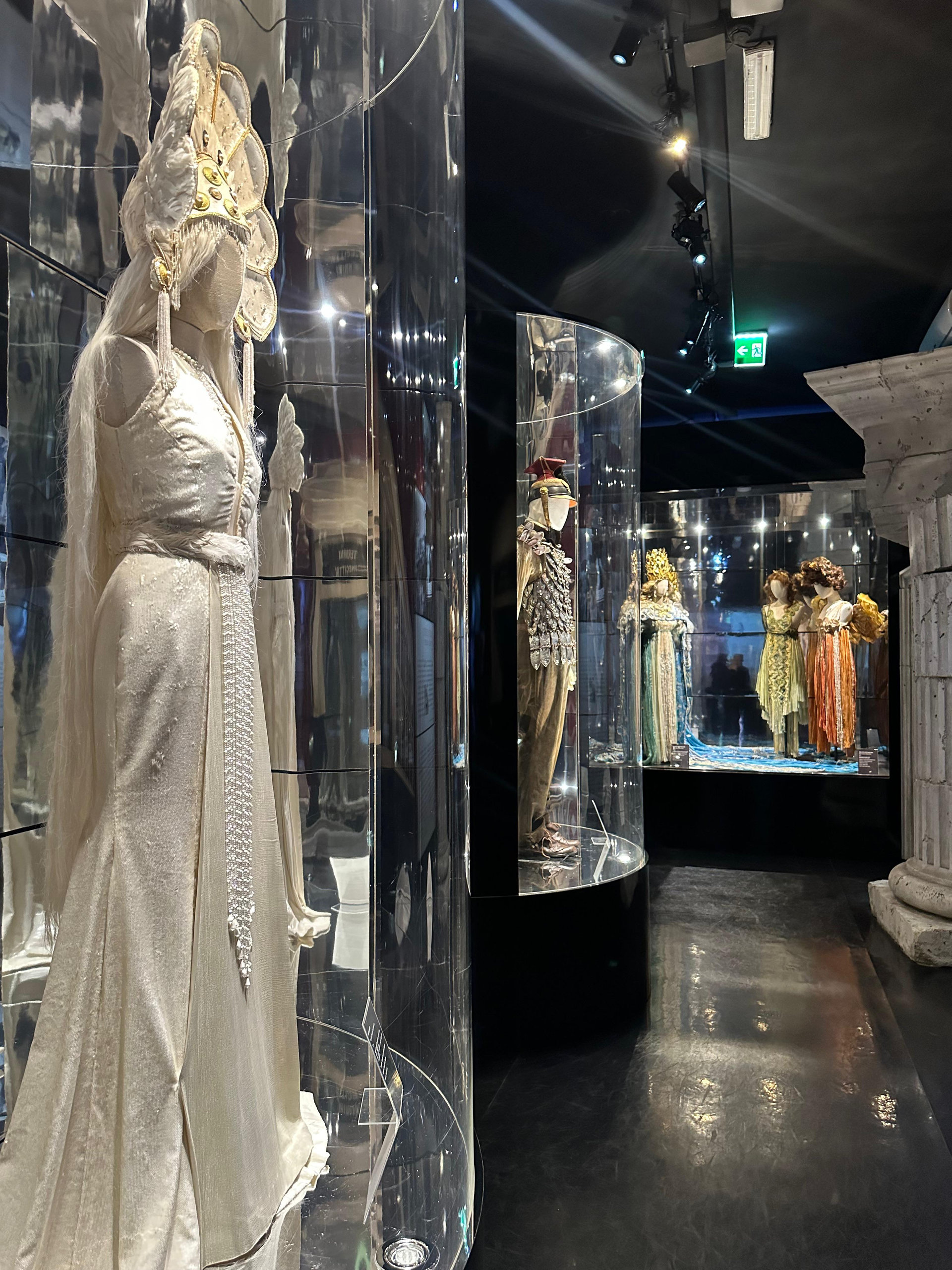 Film costumes displayed in glass cases in the Cinecittà archive