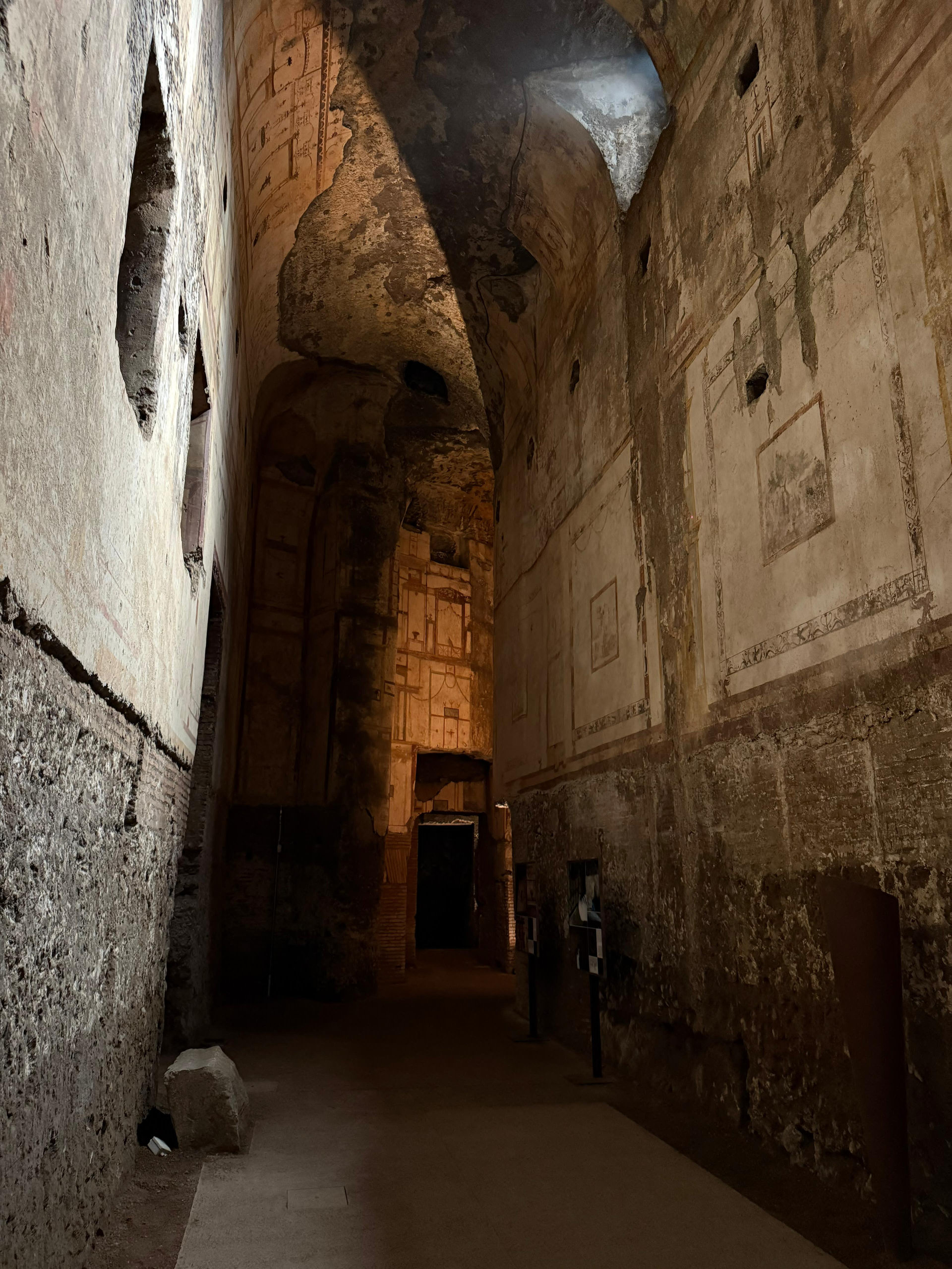 A long vaulted corridor of the Domus Aurea lit by shafts of daylight