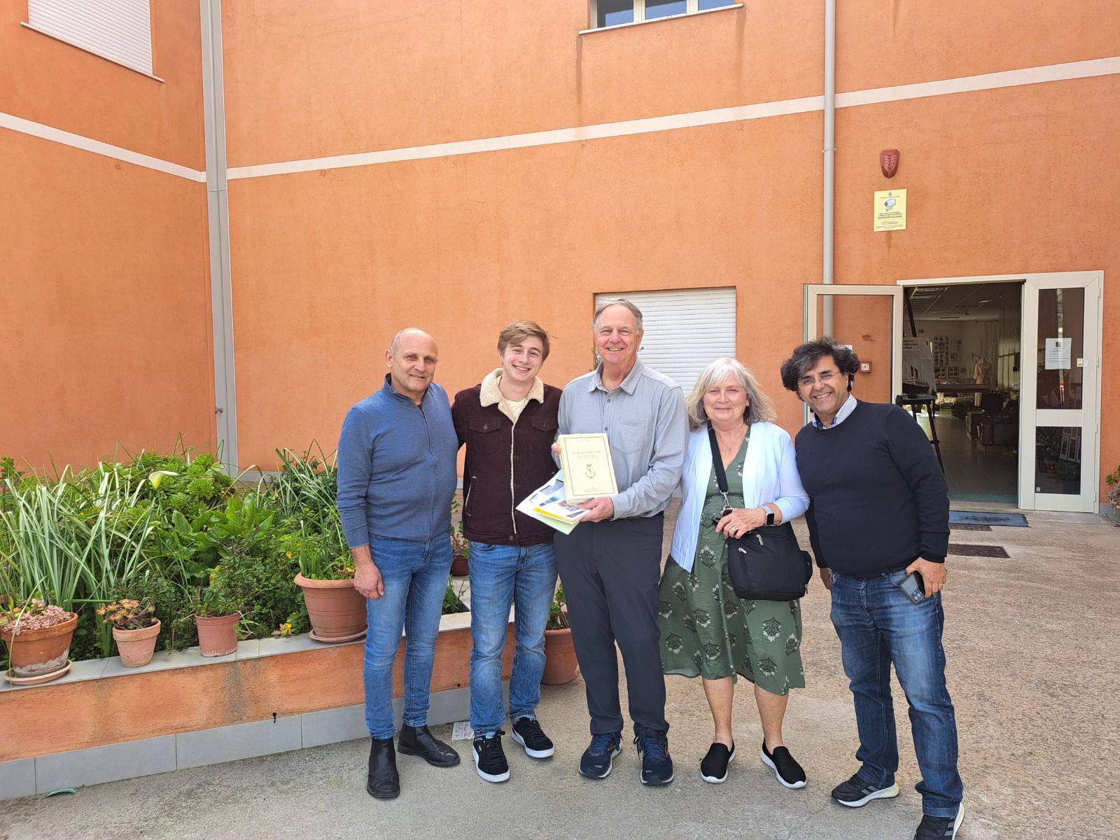 A family with their guide outside the town hall where the records were found
