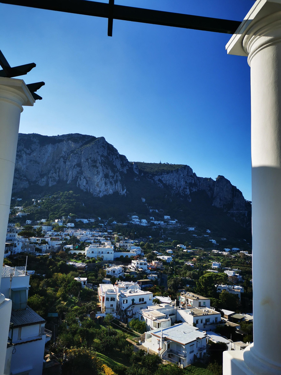 The cliffs and white houses of Capri seen from a colonnaded terrace