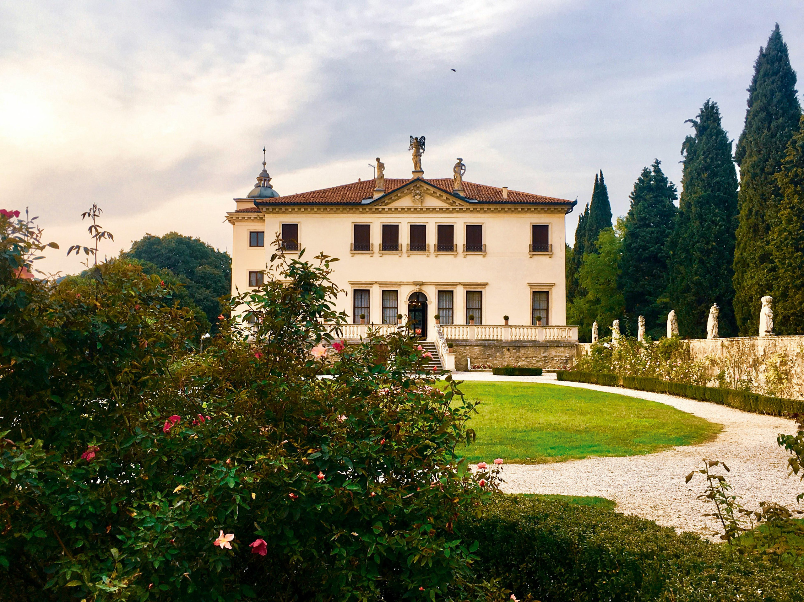 A Palladian villa in the Veneto seen from its rose garden