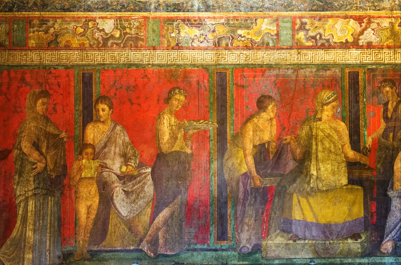 Ancient Roman wall fresco of draped figures on a vivid red background with decorative borders