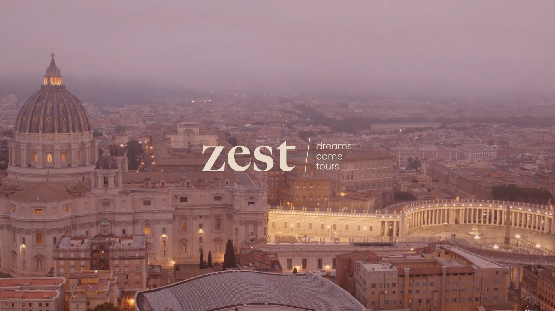 Aerial view of St Peter's dome and the colonnade at dusk with the Zest logo and tagline over the misty skyline