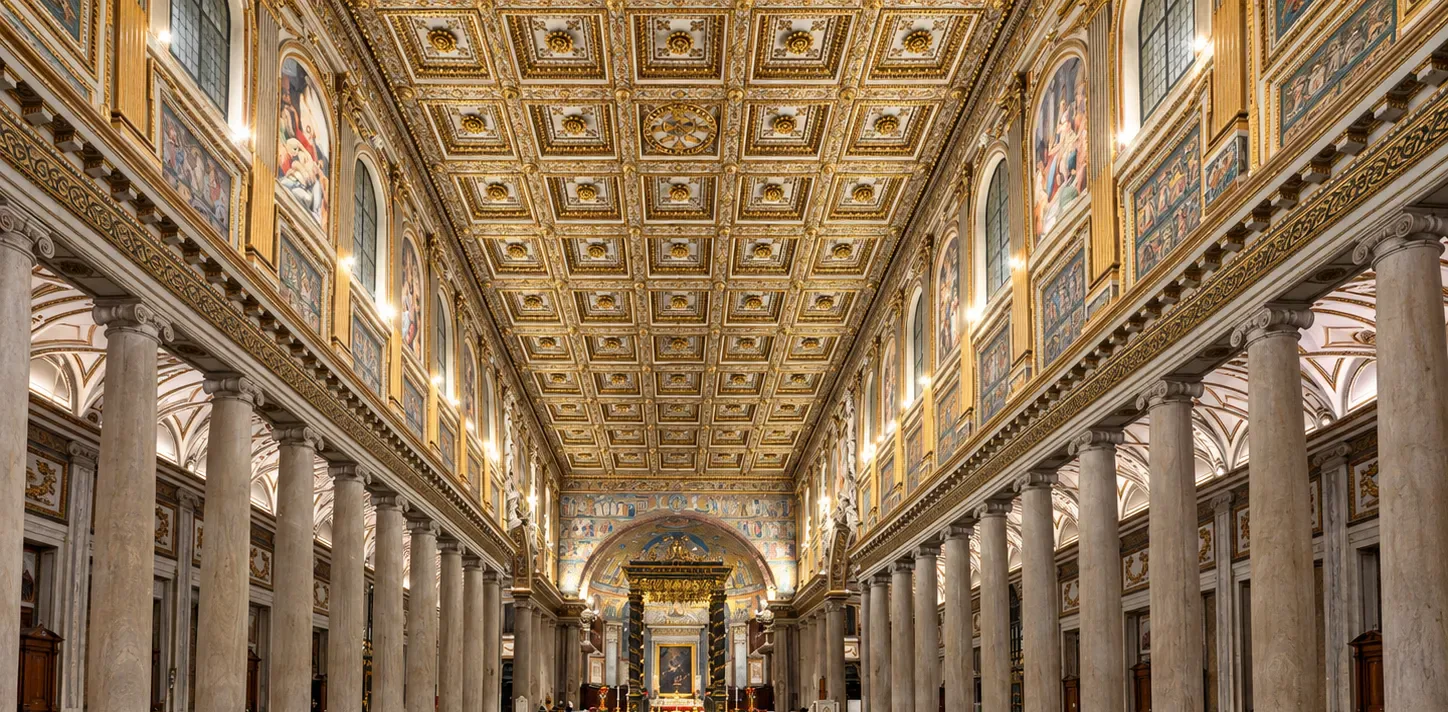 The nave of Santa Maria Maggiore in Rome, with its gilded coffered ceiling, marble columns and the baldachin over the high altar