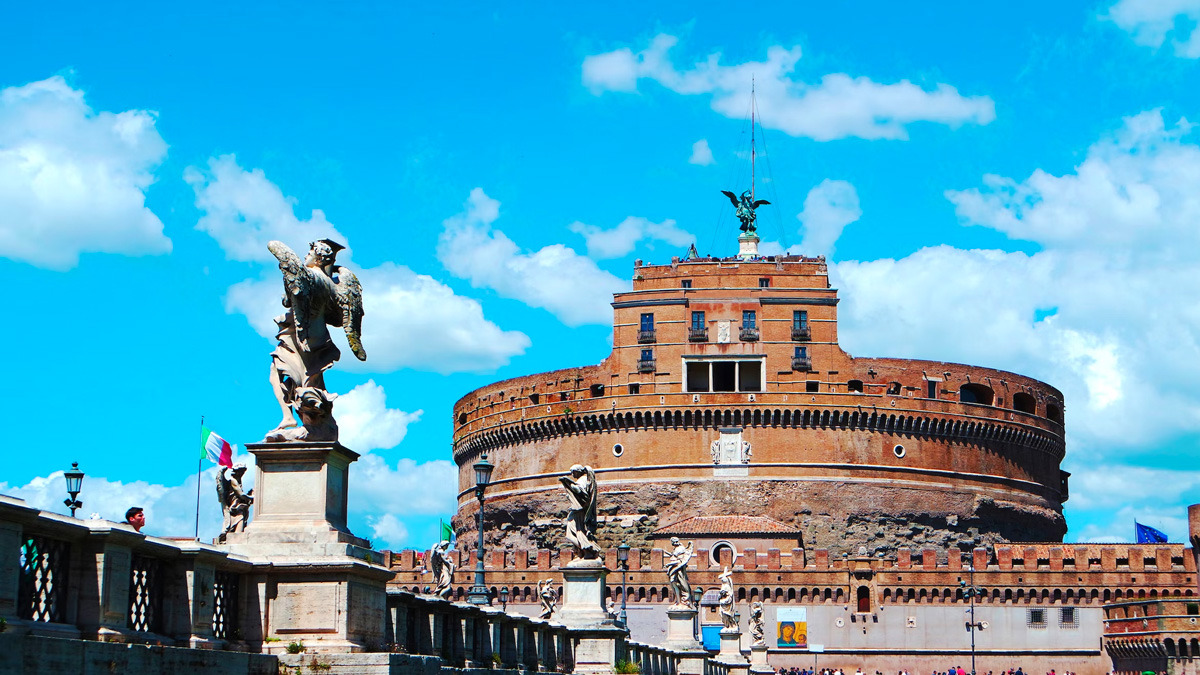 Castel Sant'Angelo's round brick fortress seen from the bridge, with an angel statue in the foreground