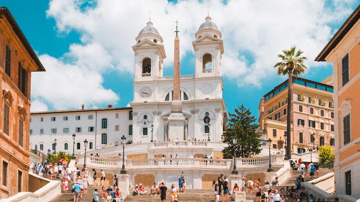 Spanish Steps and the twin-towered Trinità dei Monti church crowded with visitors in Rome