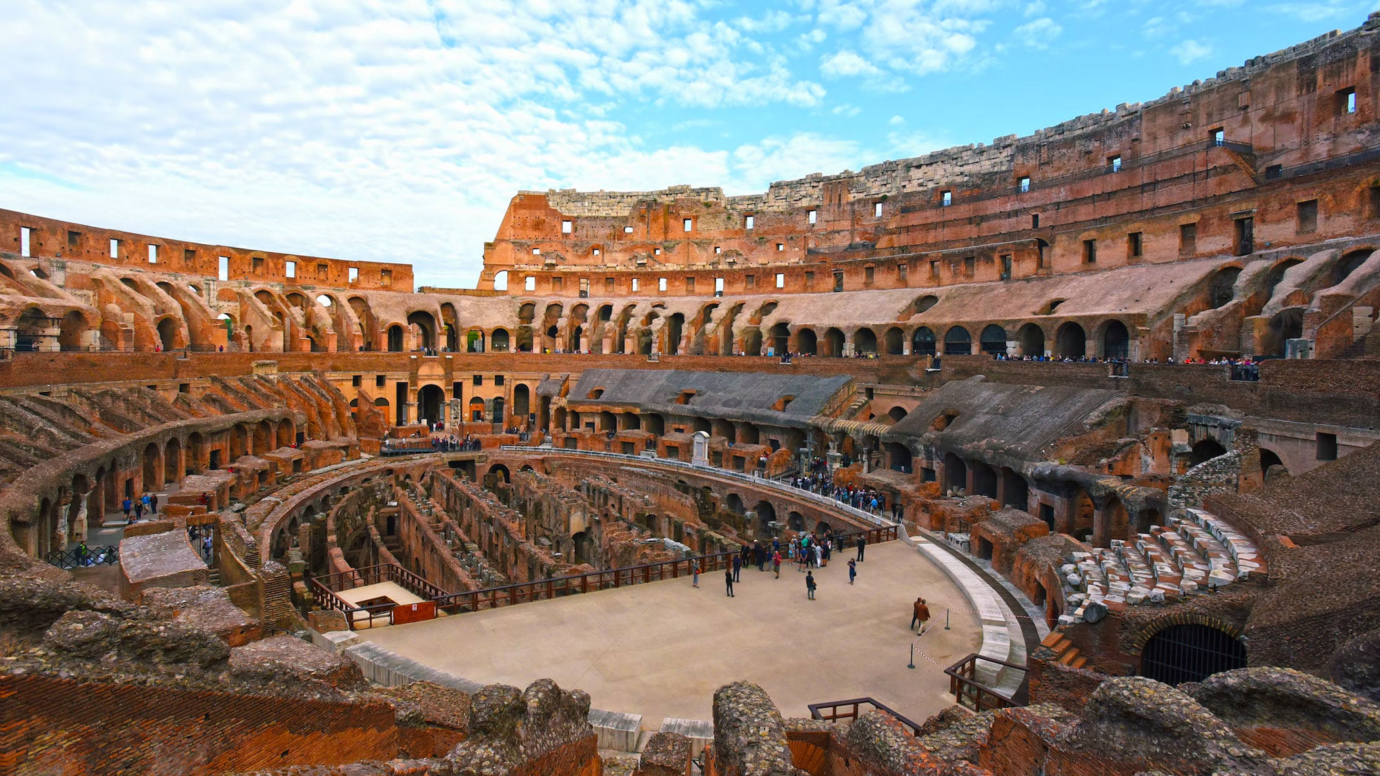 Interior of the Colosseum with its tiered arches and the exposed underground chambers of the arena floor