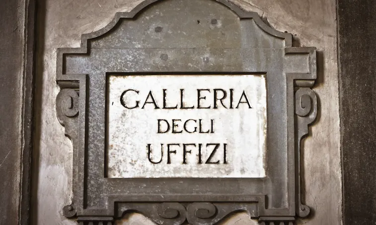 Stone plaque reading Galleria degli Uffizi set in a decorated stone frame