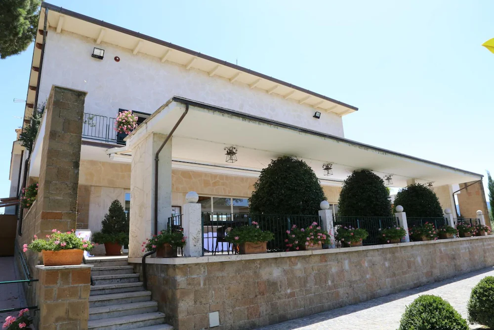 Winery building with a covered terrace and flowering planters