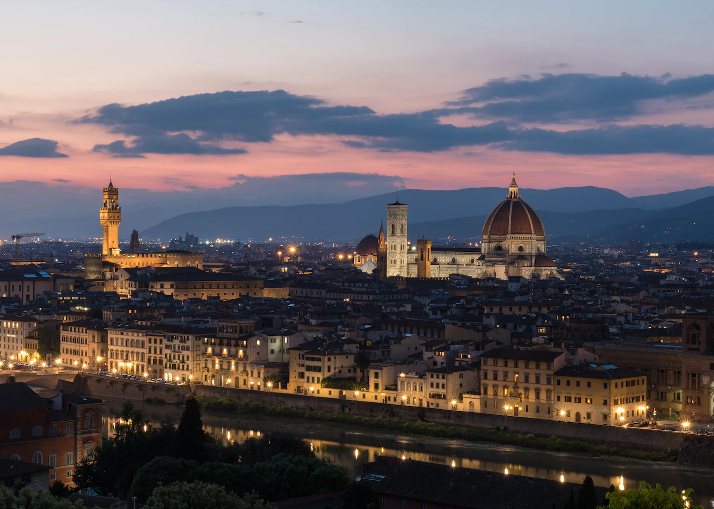 Florence skyline at dusk with the Duomo dome, Giotto's bell tower and Palazzo Vecchio tower