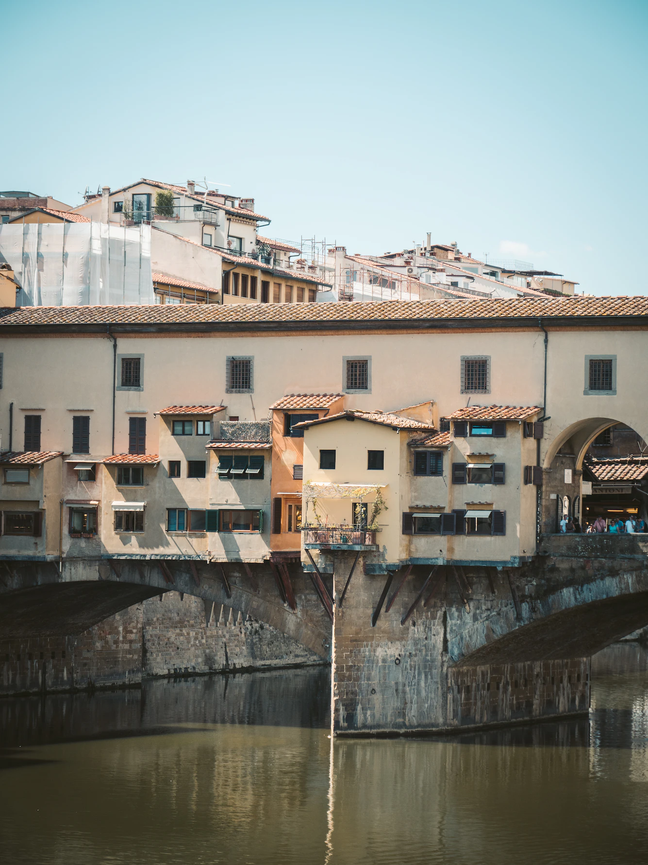 Ponte Vecchio with its overhanging shops reflected in the Arno at Florence