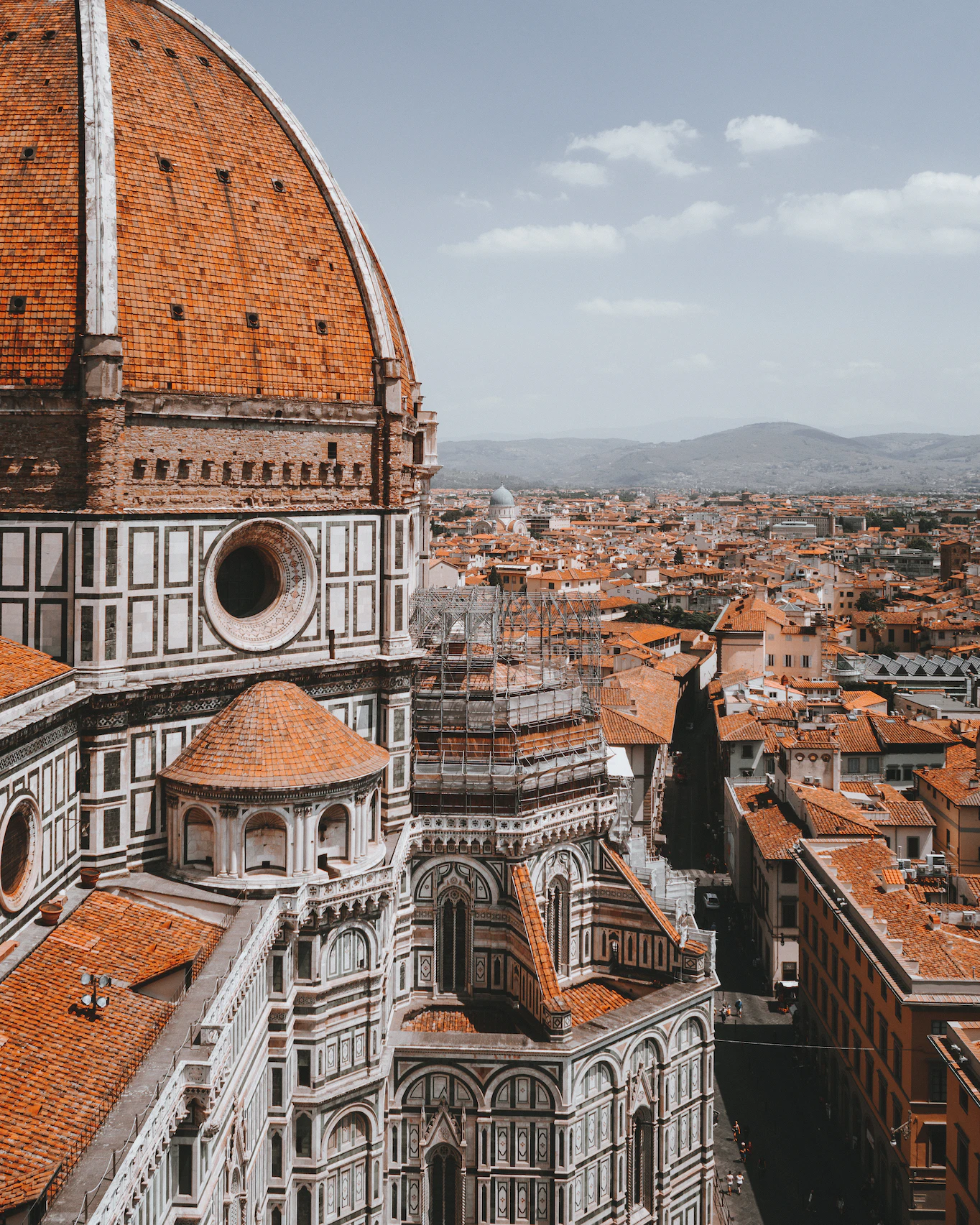 Terracotta dome of Florence Cathedral and the rooftops of the city stretching to the hills