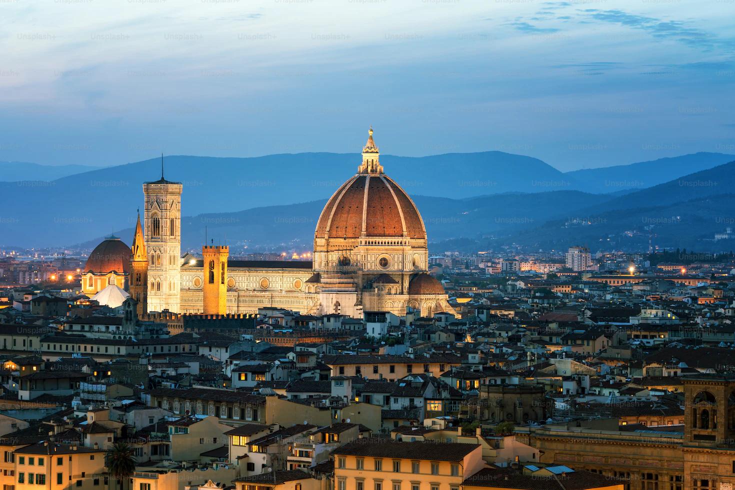 Florence cathedral dome and Giotto's bell tower at blue hour above the city rooftops