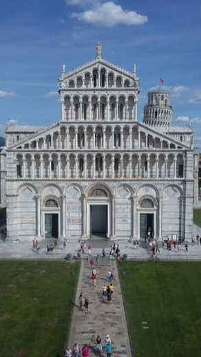 Pisa Cathedral facade with its tiers of white marble arcades and the Leaning Tower behind
