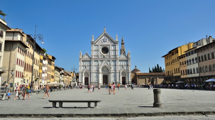 Basilica of Santa Croce's white marble facade across its open square in Florence