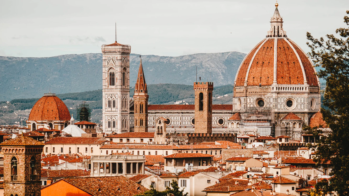 Florence skyline with the cathedral dome, Giotto's bell tower and Palazzo Vecchio tower before distant hills