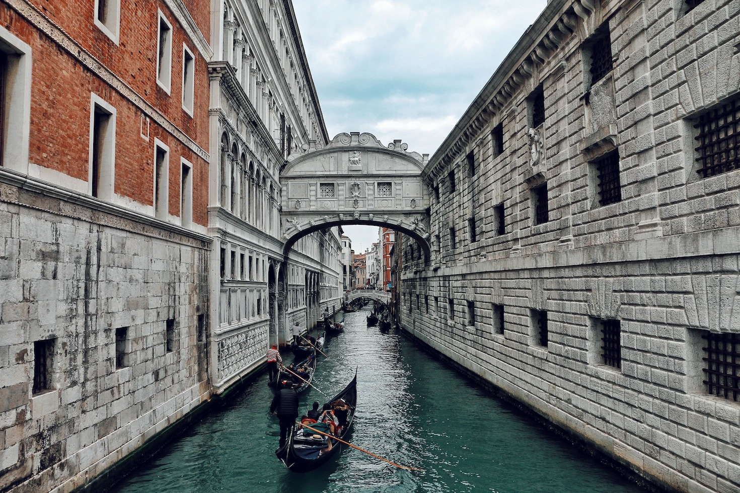 The Bridge of Sighs spanning a narrow canal with a gondola passing below