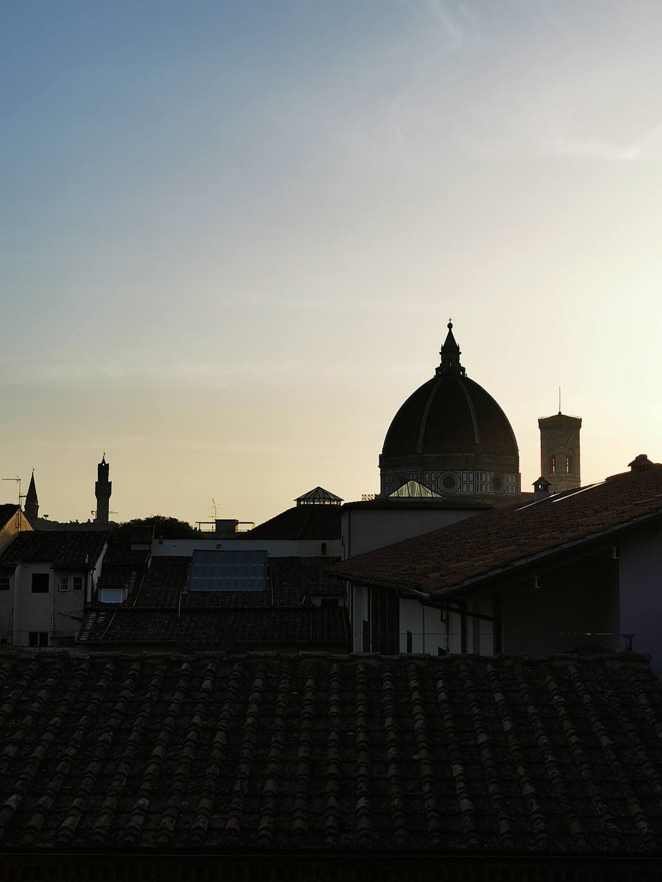 Silhouette of Florence's cathedral dome and rooftops at sunset