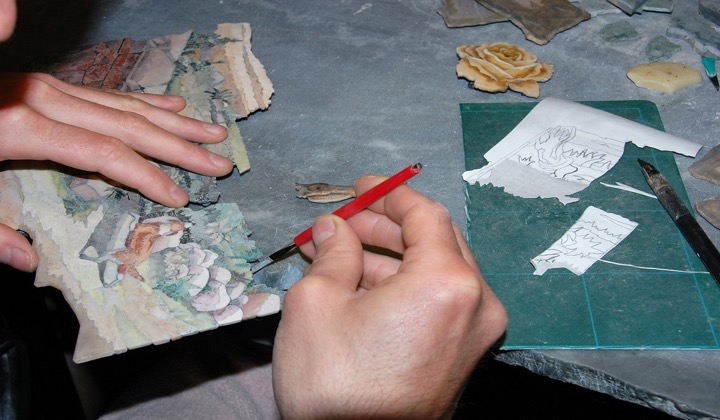 Craftsperson cutting pieces of coloured stone for a Florentine pietra dura mosaic