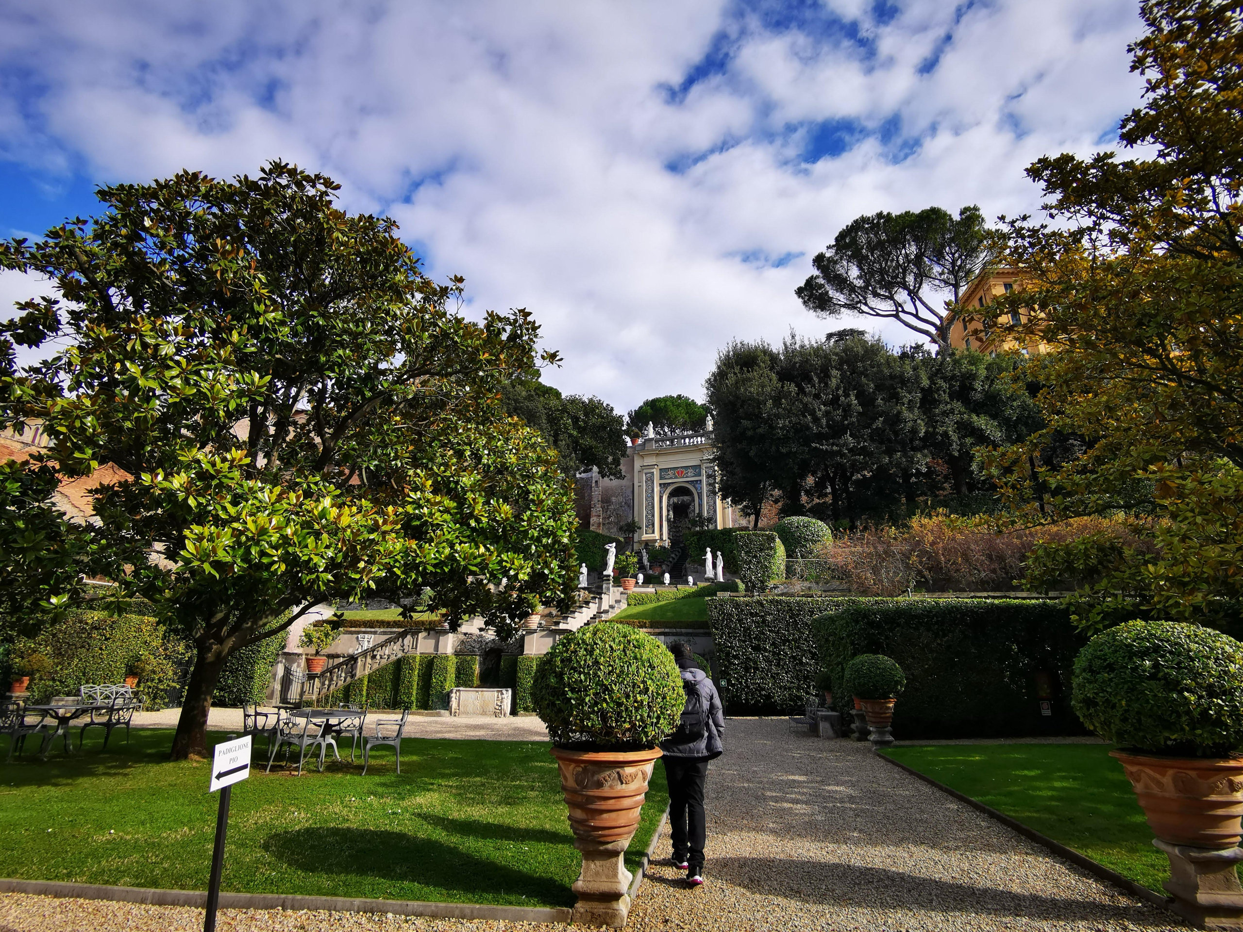 Palace garden with potted bay trees, magnolia and a stone stairway leading to a pavilion