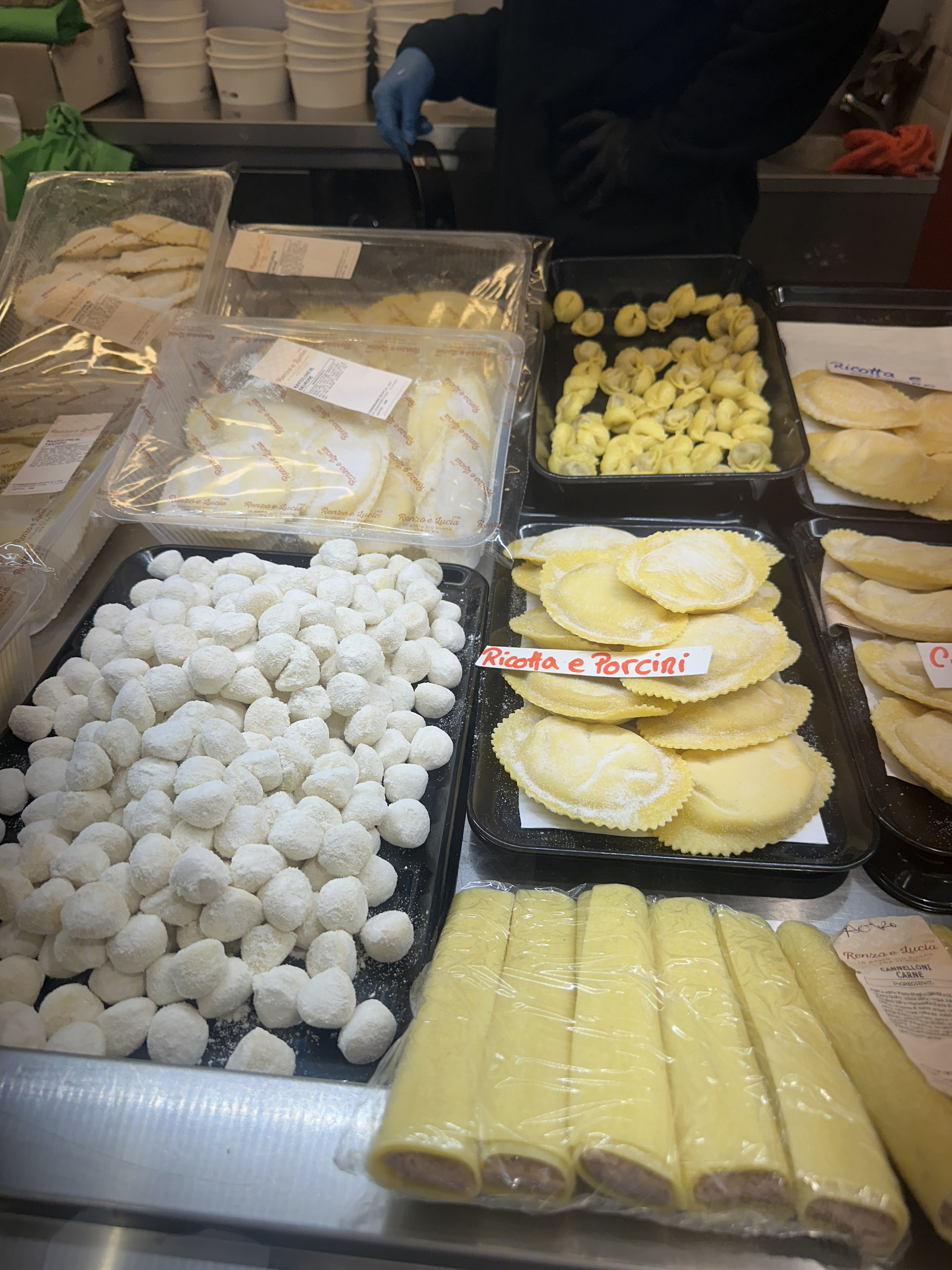 Counter of fresh pasta, with ricotta and porcini ravioli, gnocchi and rolled lasagna sheets