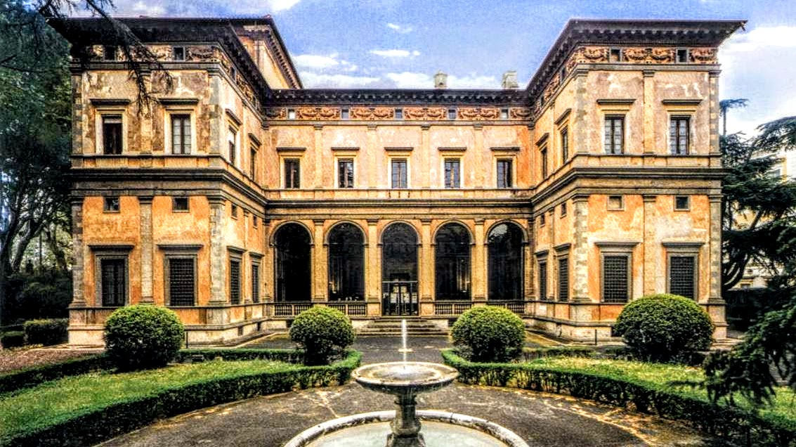 Garden front of Villa Farnesina, a Renaissance villa with open arches, clipped hedges and a small fountain