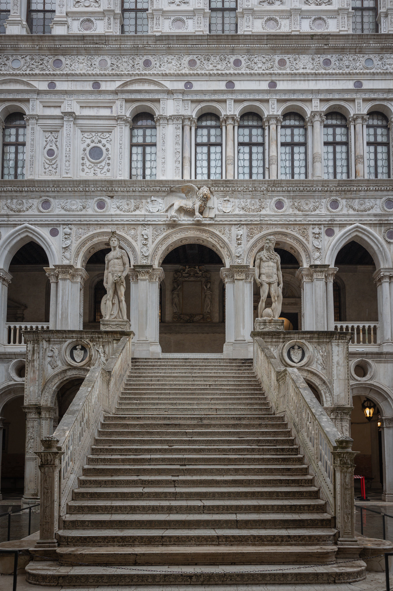 Stone staircase flanked by two statues in the courtyard of the Doge's Palace in Venice