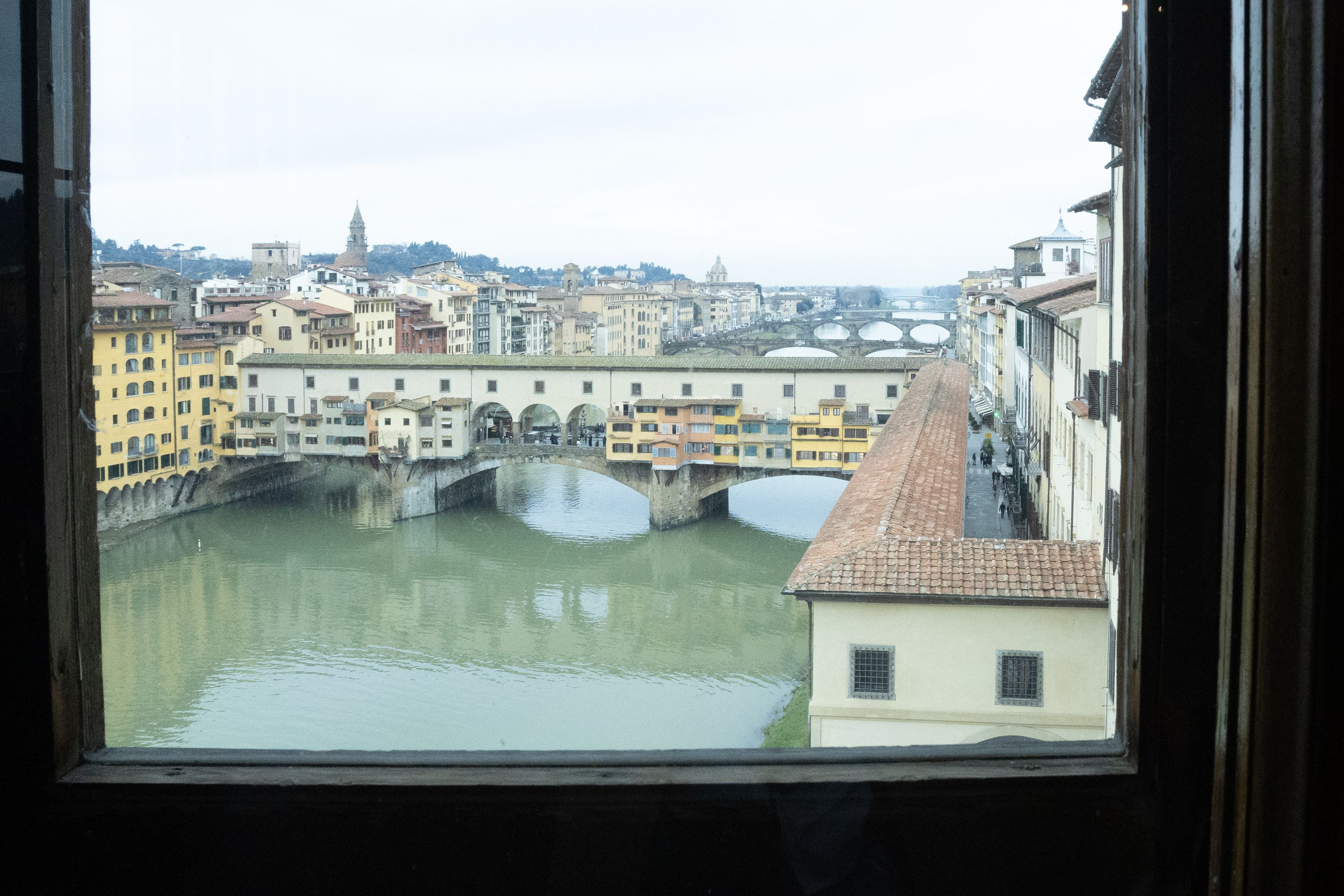 View of the Ponte Vecchio and the Arno through a wooden window of the Uffizi