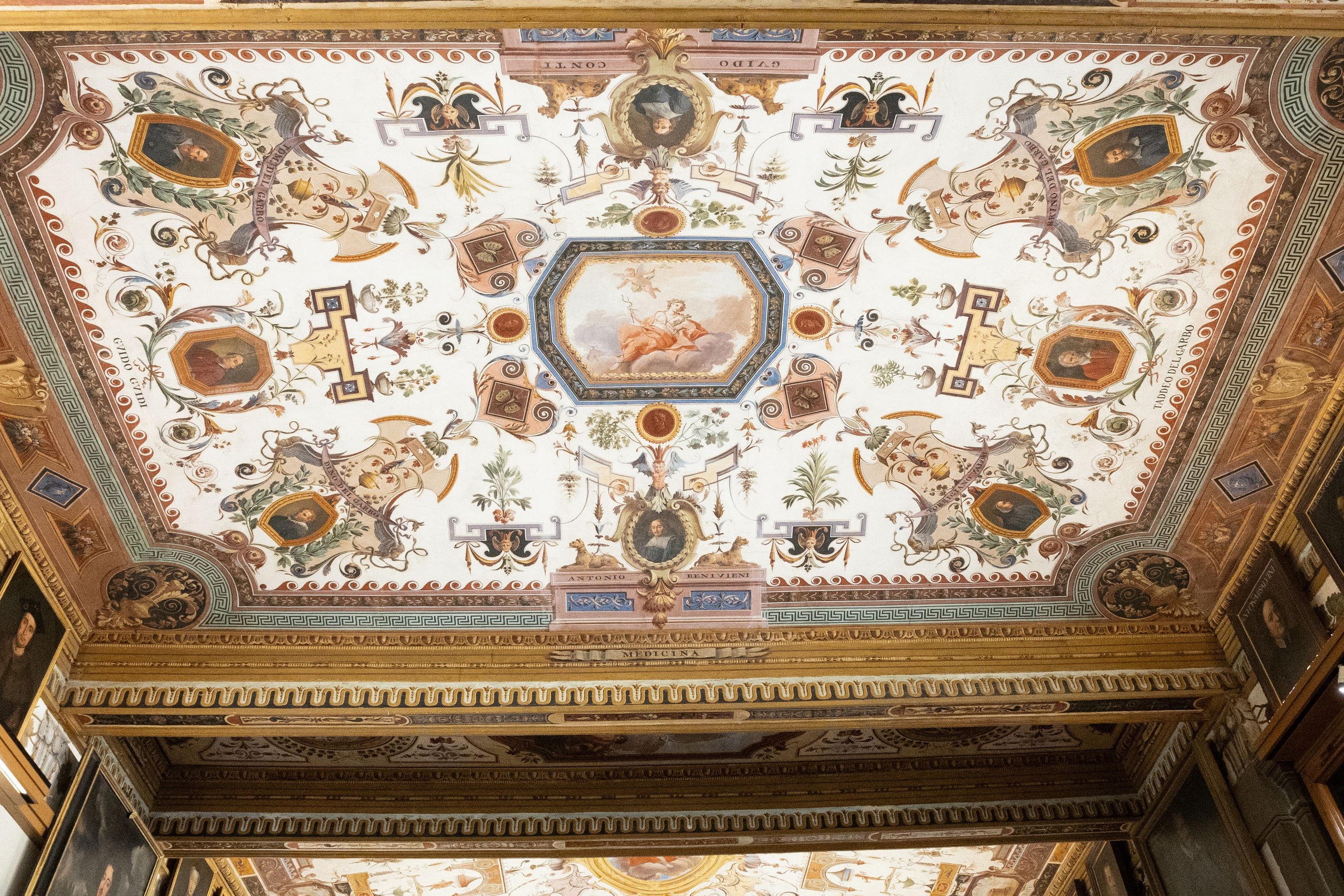 Ornate grotesque-decorated ceiling with painted medallions and gilded cornices