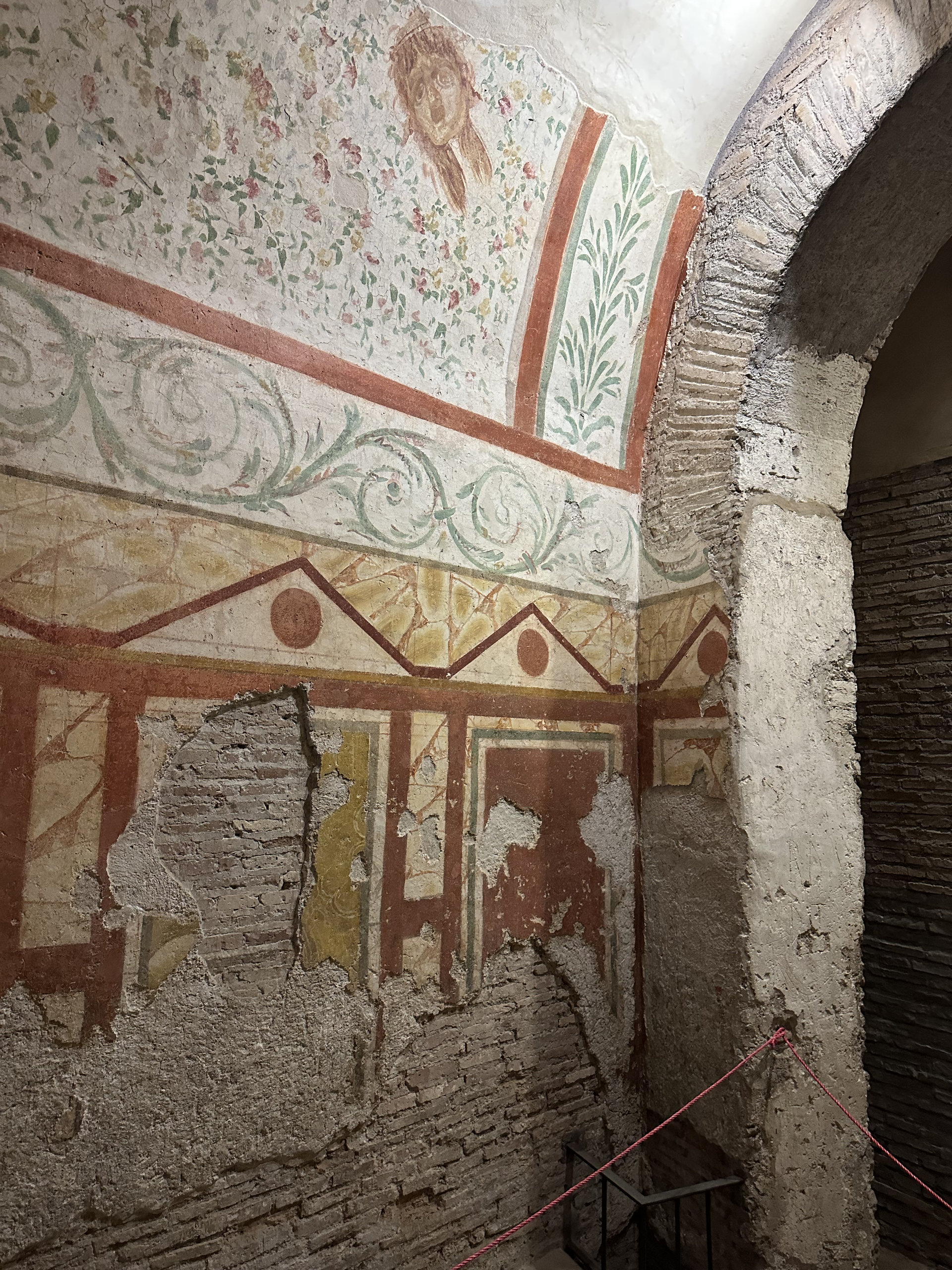 Corner of a Roman room with painted floral ceiling, scrollwork and geometric wall decoration