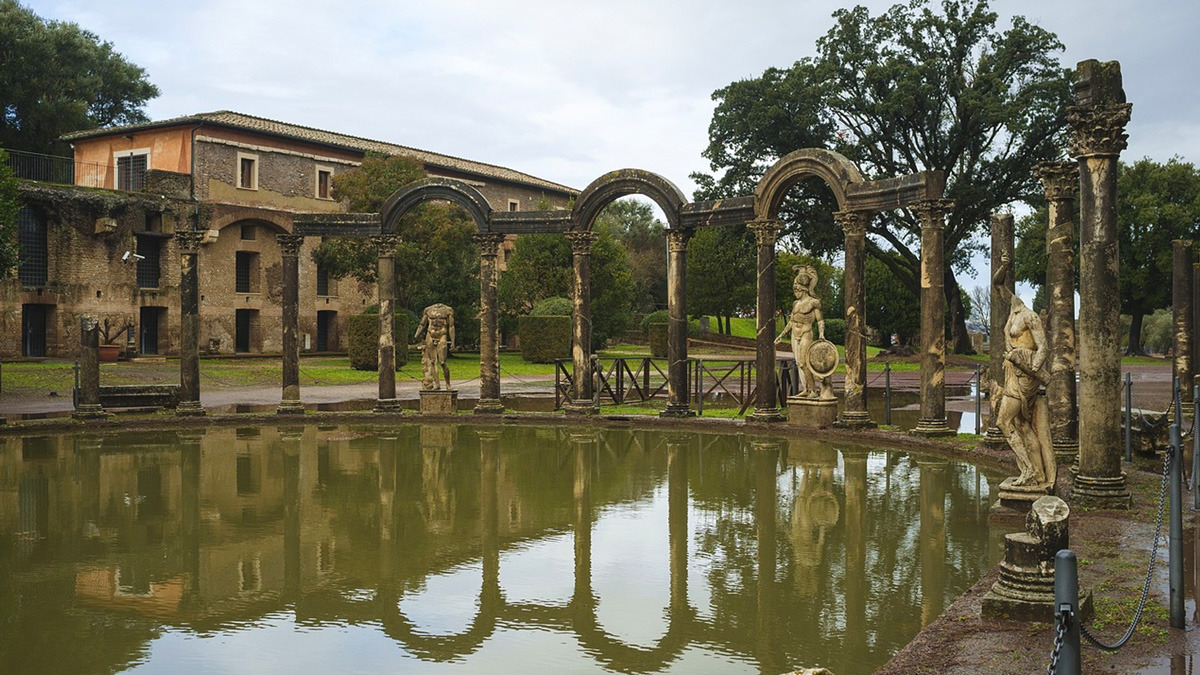 Canopus pool at Hadrian's Villa with arcaded colonnade, statues and reflections