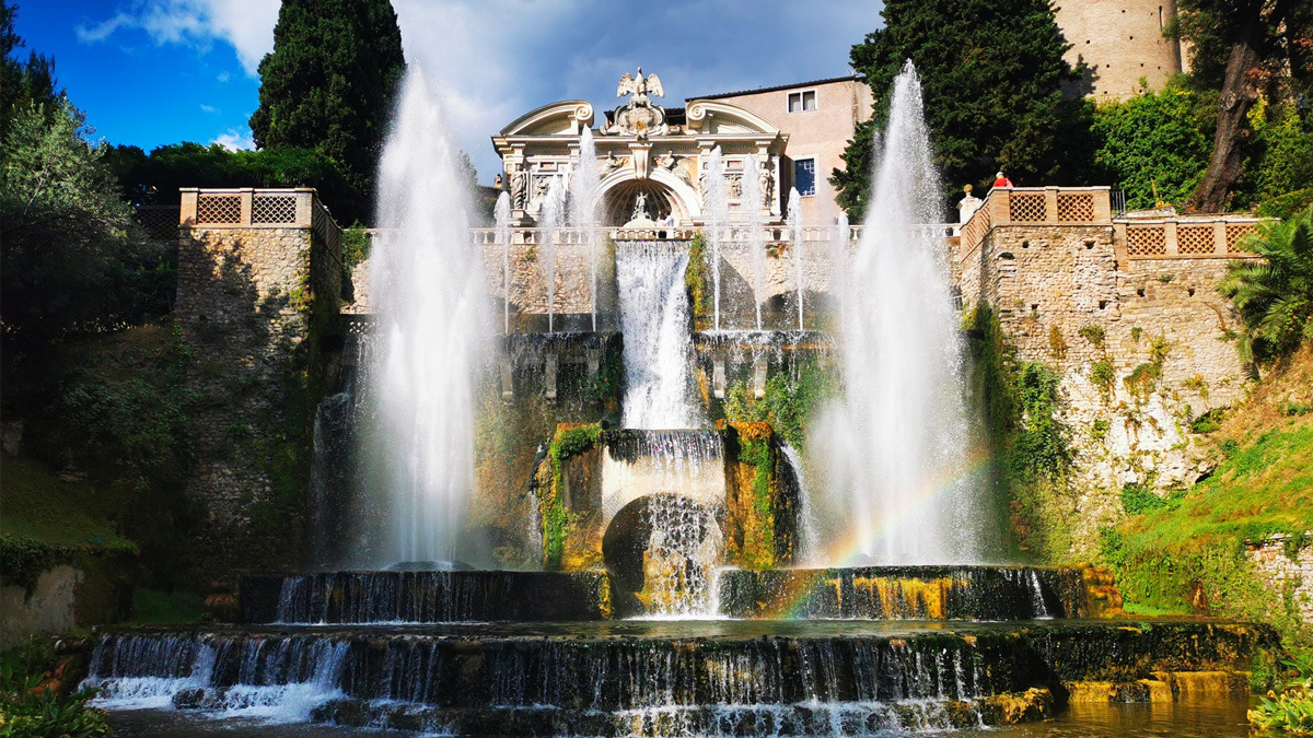 Cascading fountains and rainbow mist before a stone balustrade at Villa d'Este