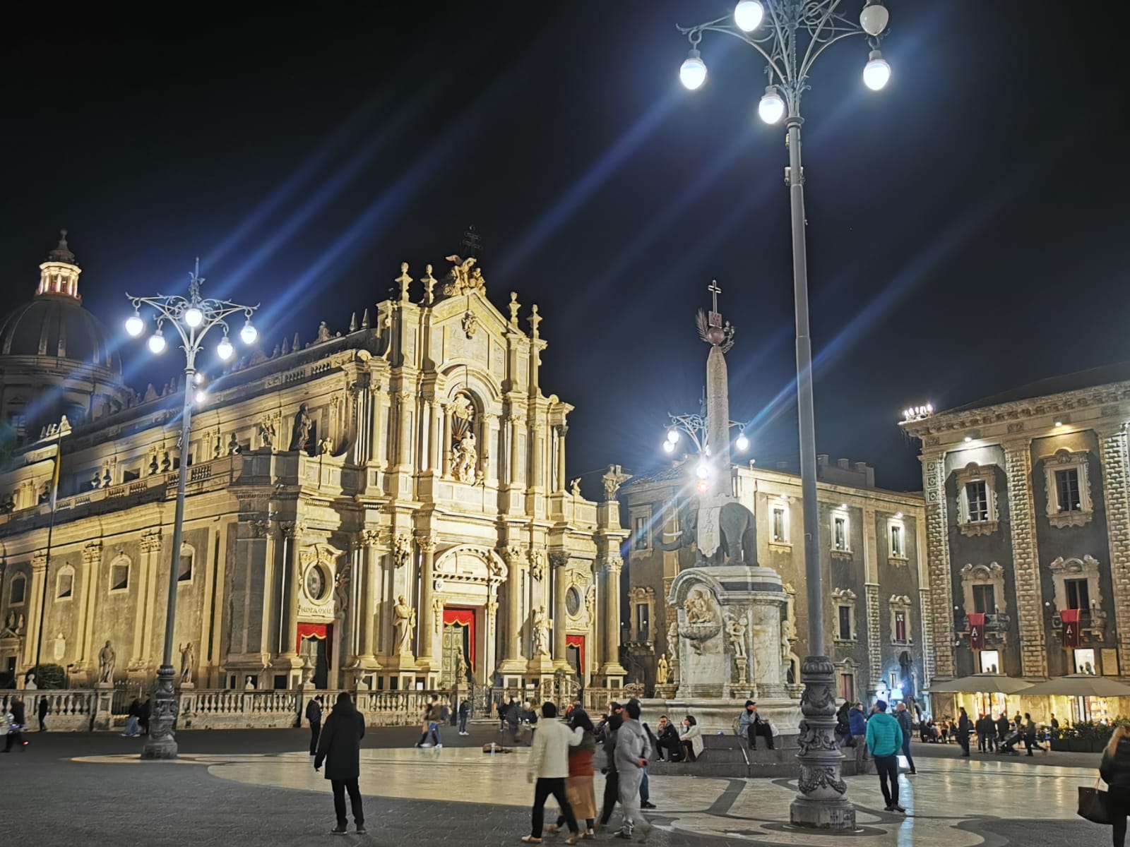 Catania's cathedral square at night, with the Baroque cathedral and the elephant fountain beneath street lamps