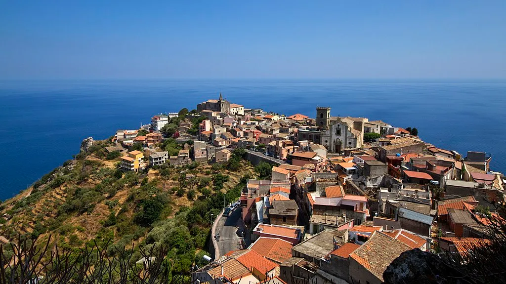 Terracotta-roofed hilltop village overlooking the deep blue Sicilian sea