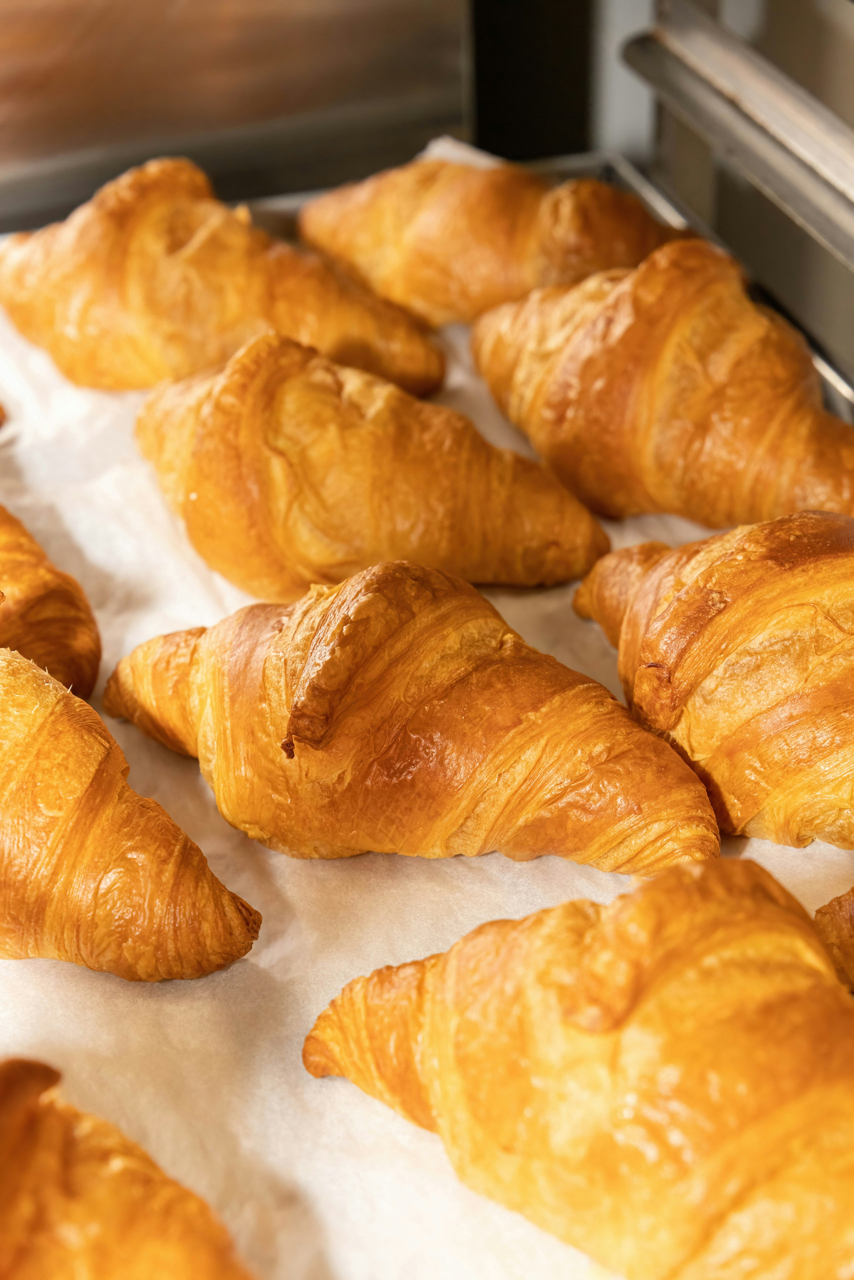 Tray of freshly baked golden croissants
