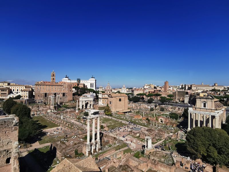 Panorama of the Roman Forum with temple columns and ruins stretching towards the Capitoline Hill